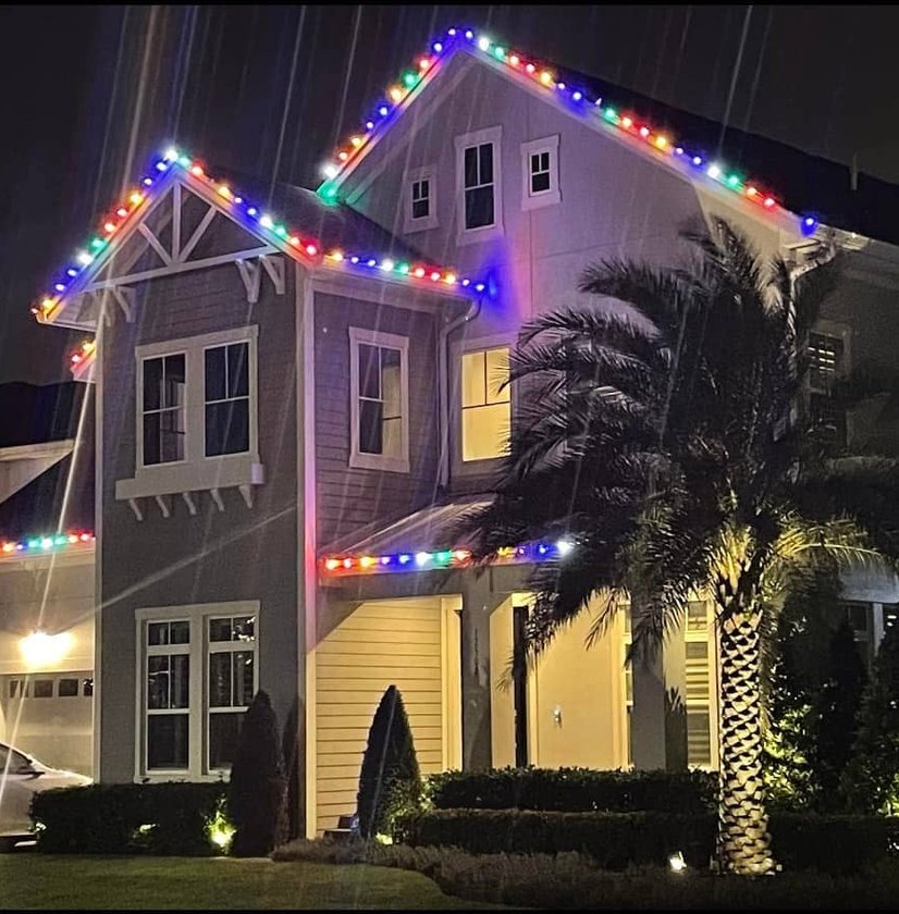 Multi-color holiday lighting on two-story home