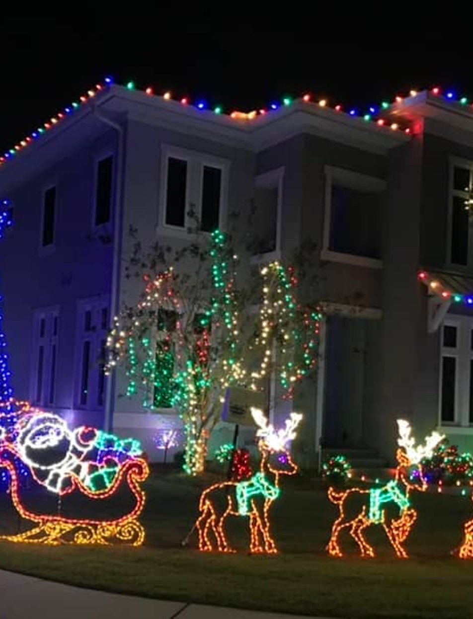 Professional Christmas light installation illuminating home exterior at night