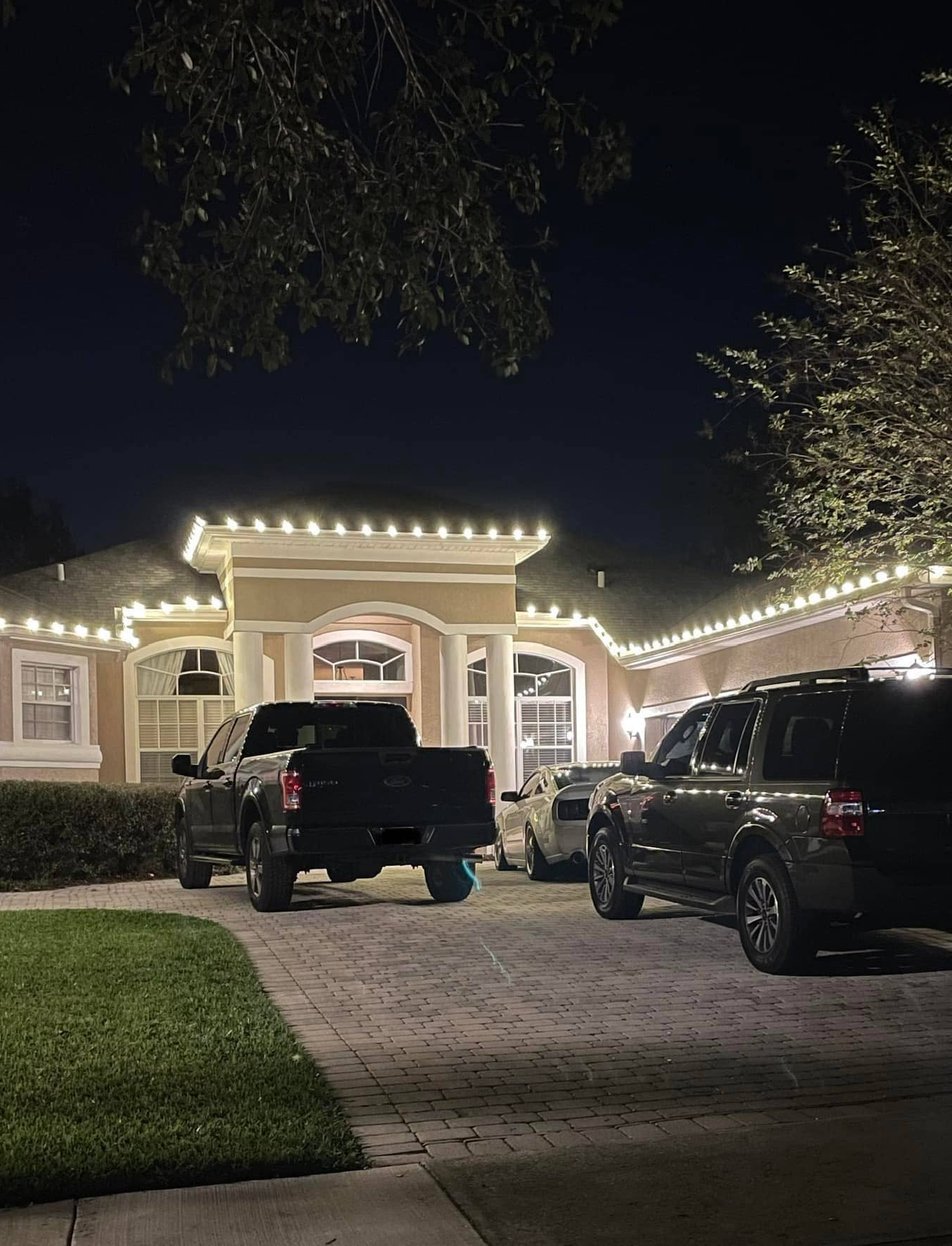 Year-round permanent lighting system illuminating home exterior