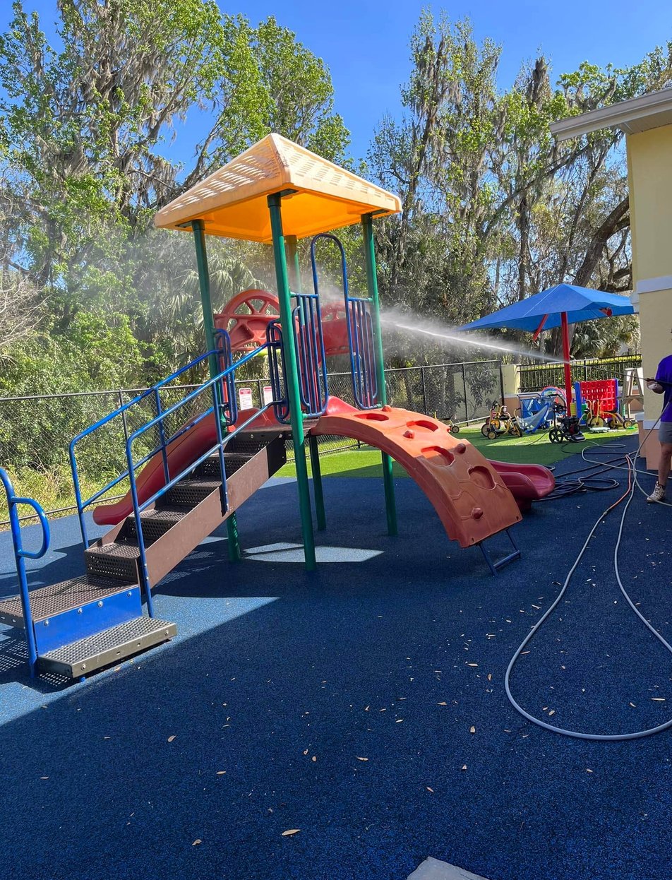 Professional pressure washing service cleaning deck and patio surfaces